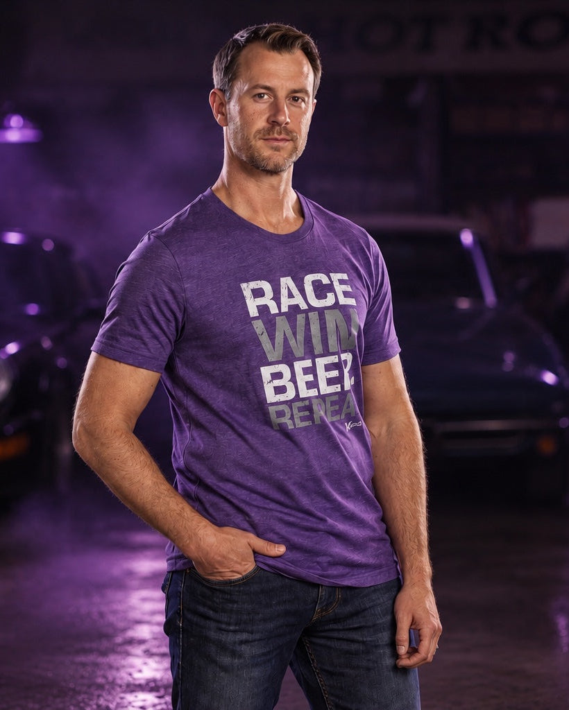 A man wearing a purple graphic t-shirt with the text 'RACE WILL BEEN BEEZ BEEZ' stands in a moody, purple-lit garage with classic cars in the background.