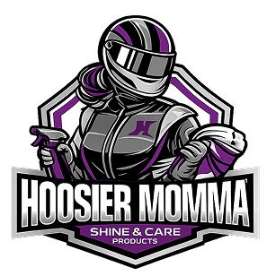 A stylized graphic logo featuring a racing driver in a helmet and suit with purple and black stripes, above the text 'Hoosier Momma Shine & Care Products' on a white background.